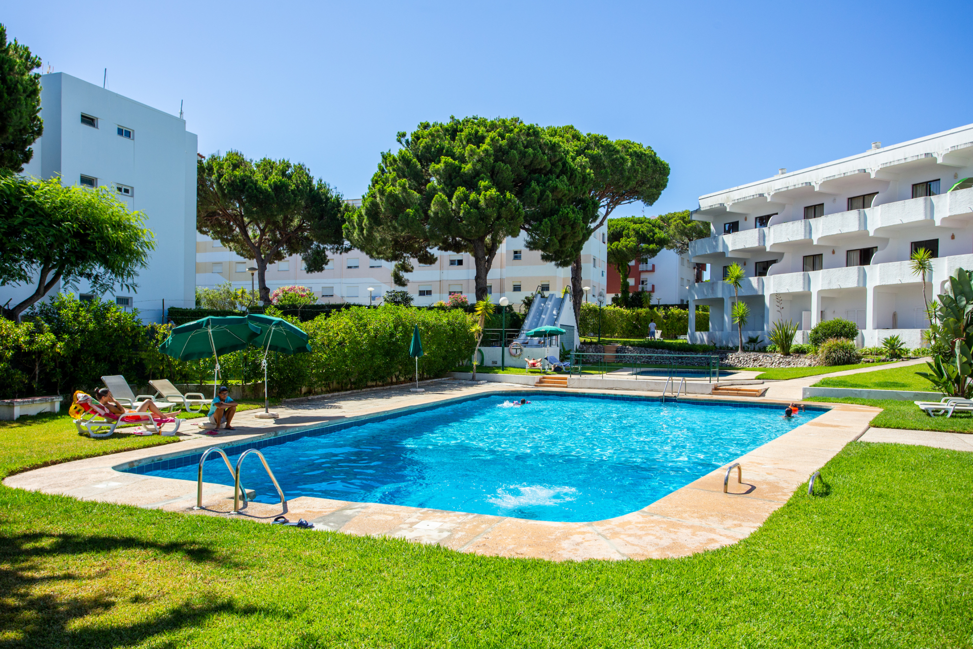 outside swimming pool with kids playing